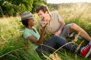 Couple laughing in a field